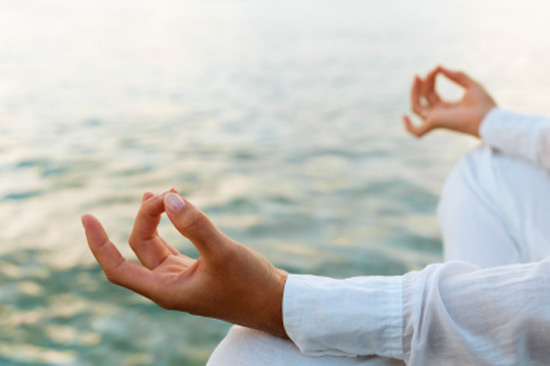 Person Meditating Near Water